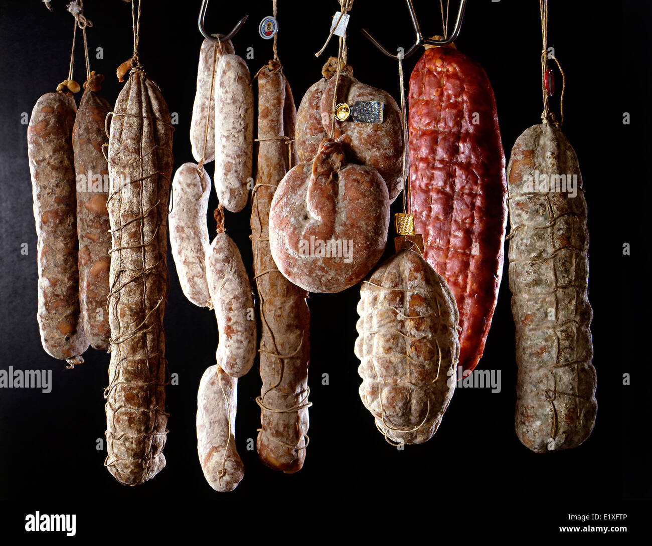 Row of  hanging salamis Stock Photo