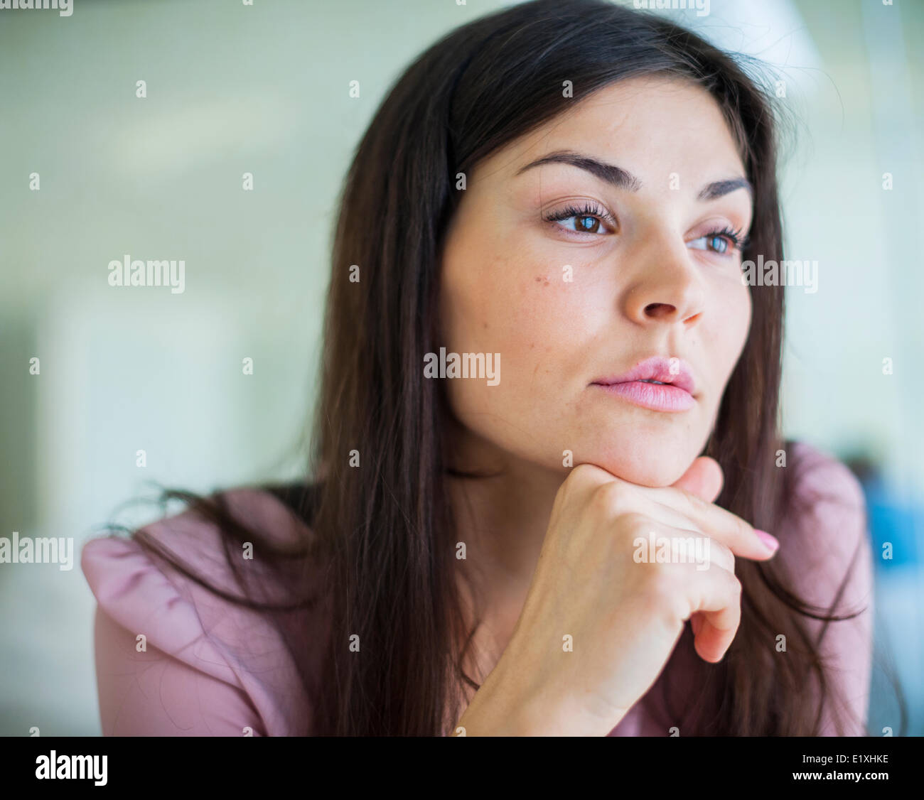 Thoughtful young businesswoman looking away in office Stock Photo