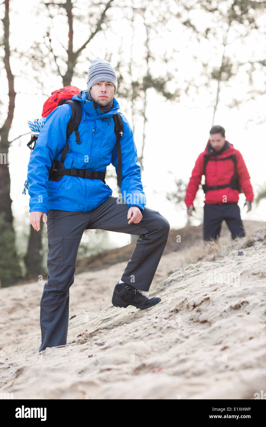 Male hiker at forest with friend in background Stock Photo