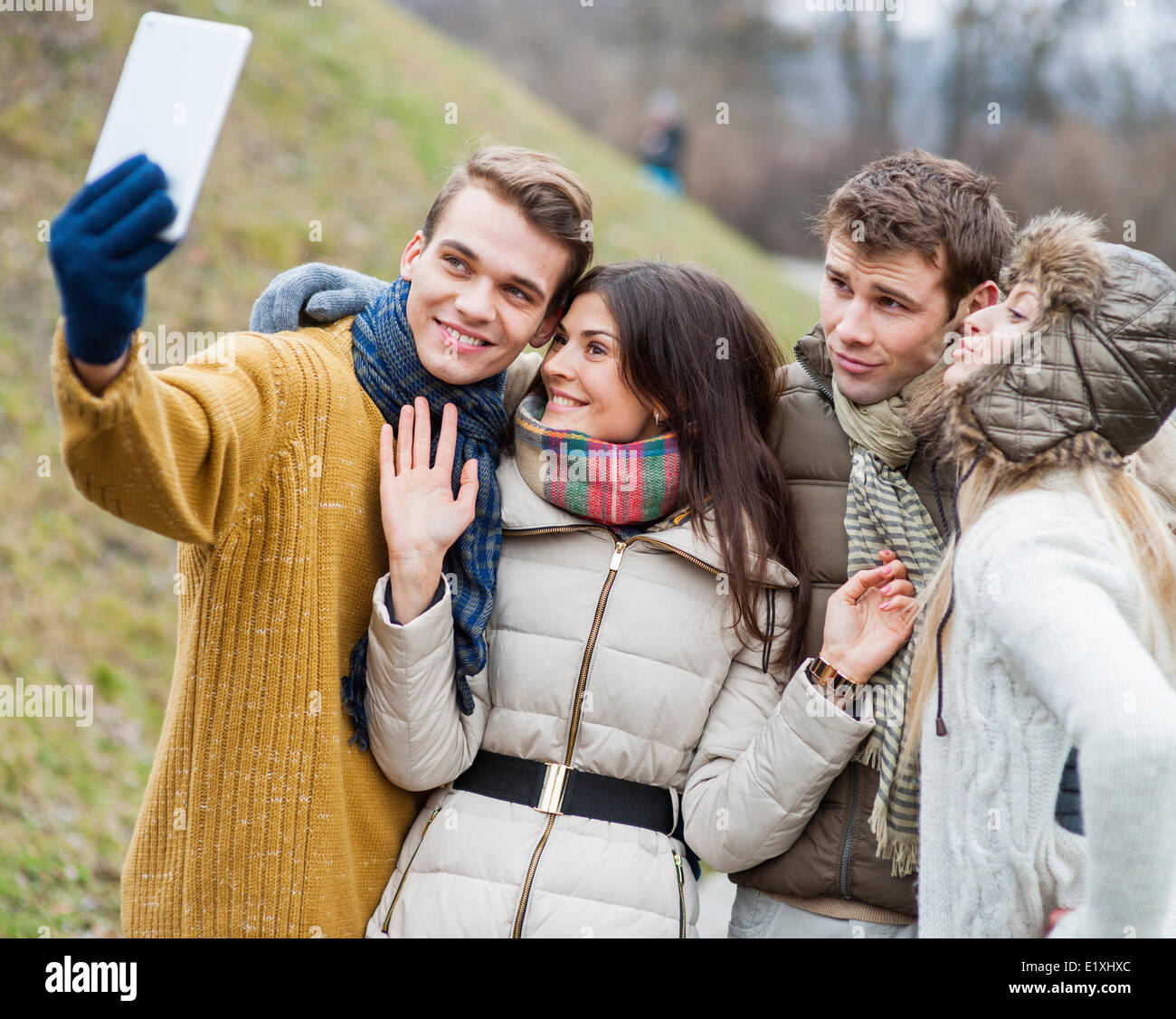 Happy couples taking self portrait through cell phone in park Stock Photo