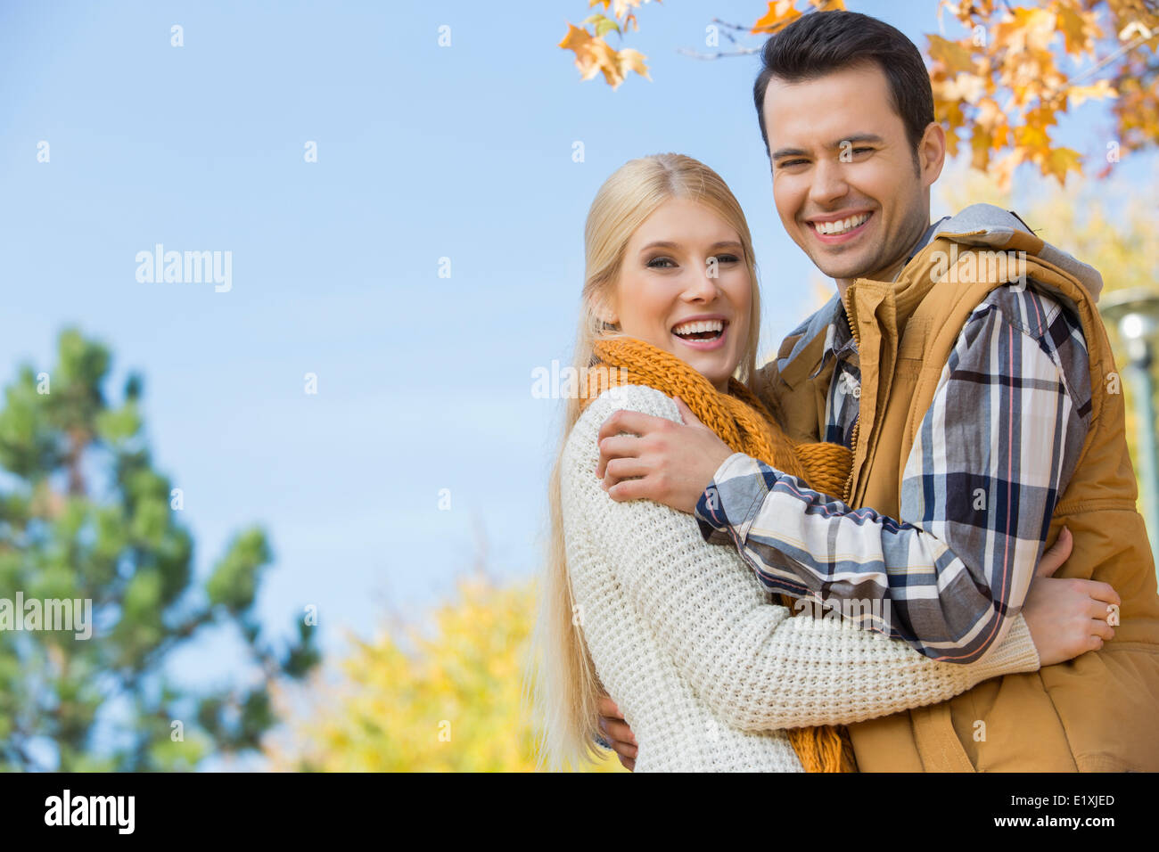 Portrait of couple hugging in park hi-res stock photography and images ...
