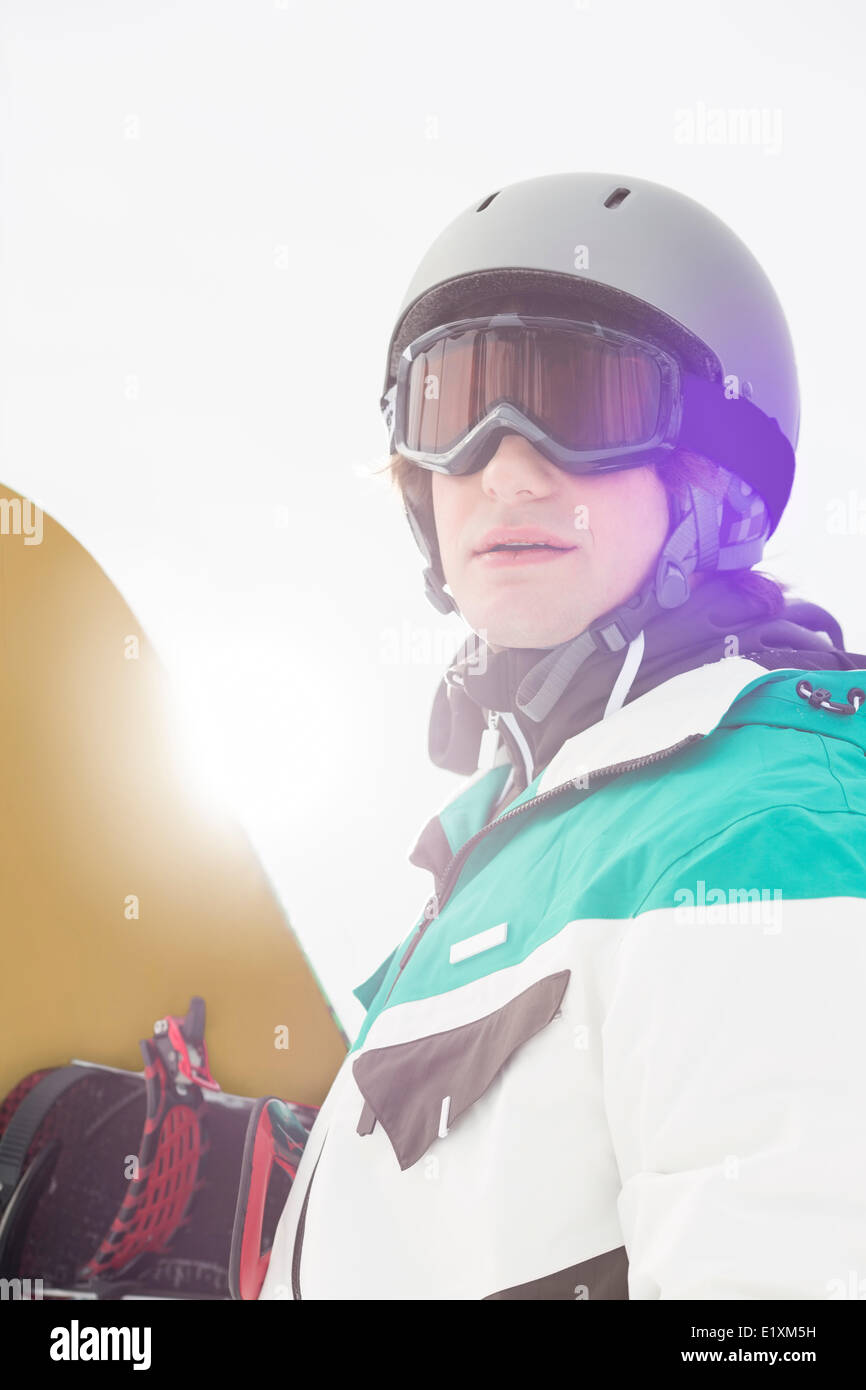 Handsome young man holding snowboard outdoors Stock Photo - Alamy