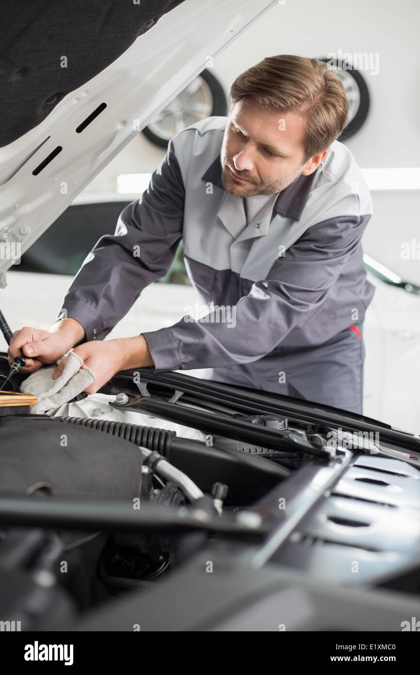 Male mechanic repairing car engine in workshop Stock Photo - Alamy