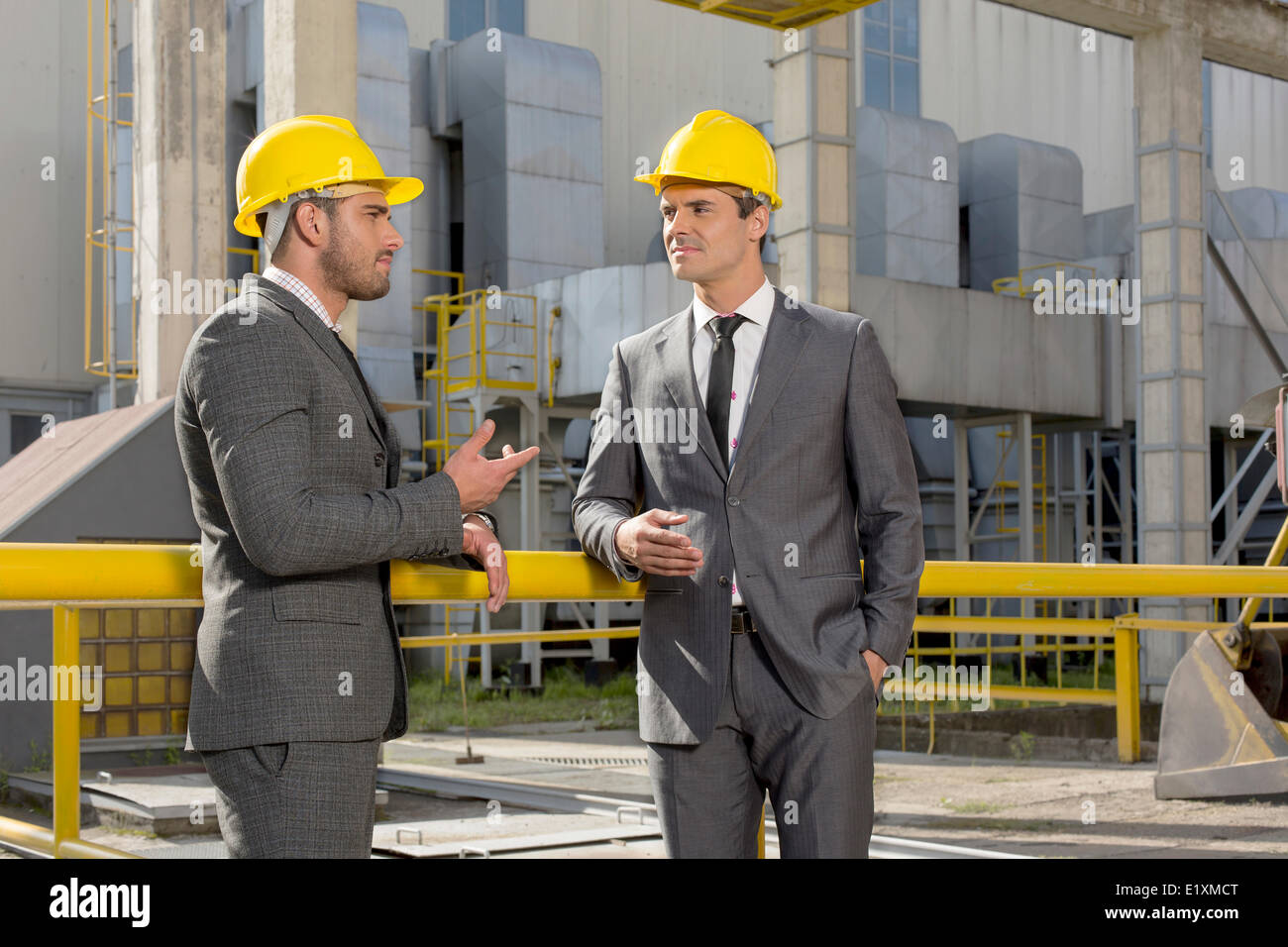 Young male architects discussing outside industry Stock Photo