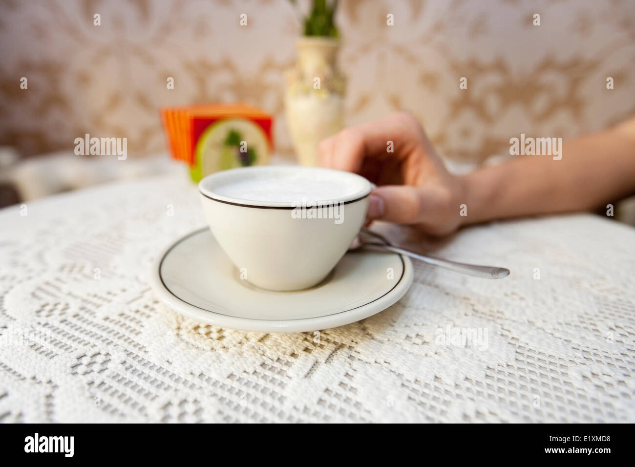 Cropped image of man having cup of coffee at table in cafe Stock Photo