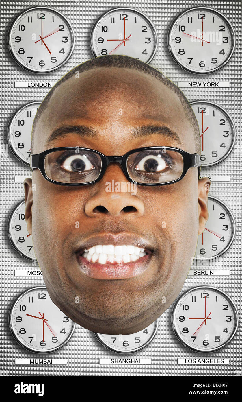 Headshot of worried man wearing glasses with various time zone clocks in background Stock Photo