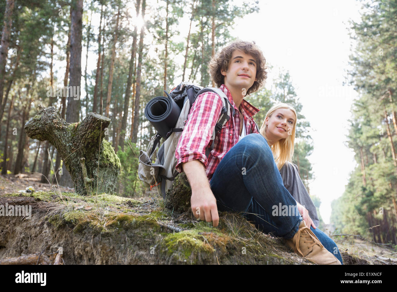 Young hiking couple relaxing in forest Stock Photo