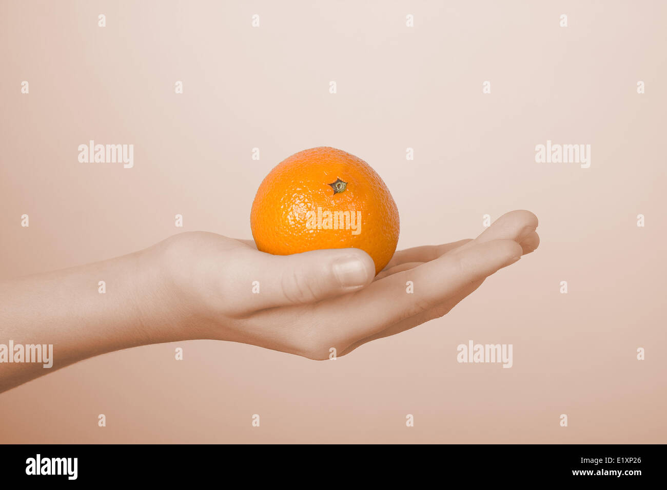 Tangerine on a children's palm Stock Photo