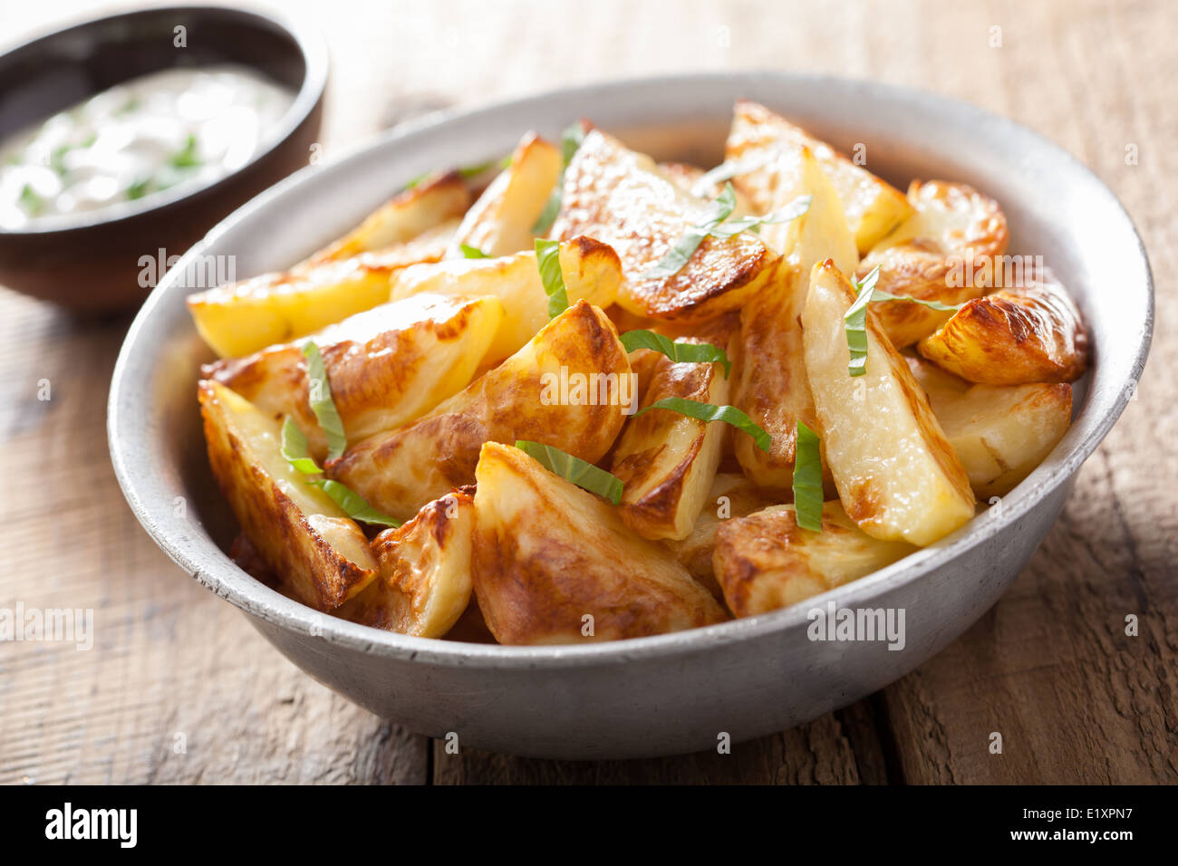 baked potato wedges with yogurt dip Stock Photo Alamy