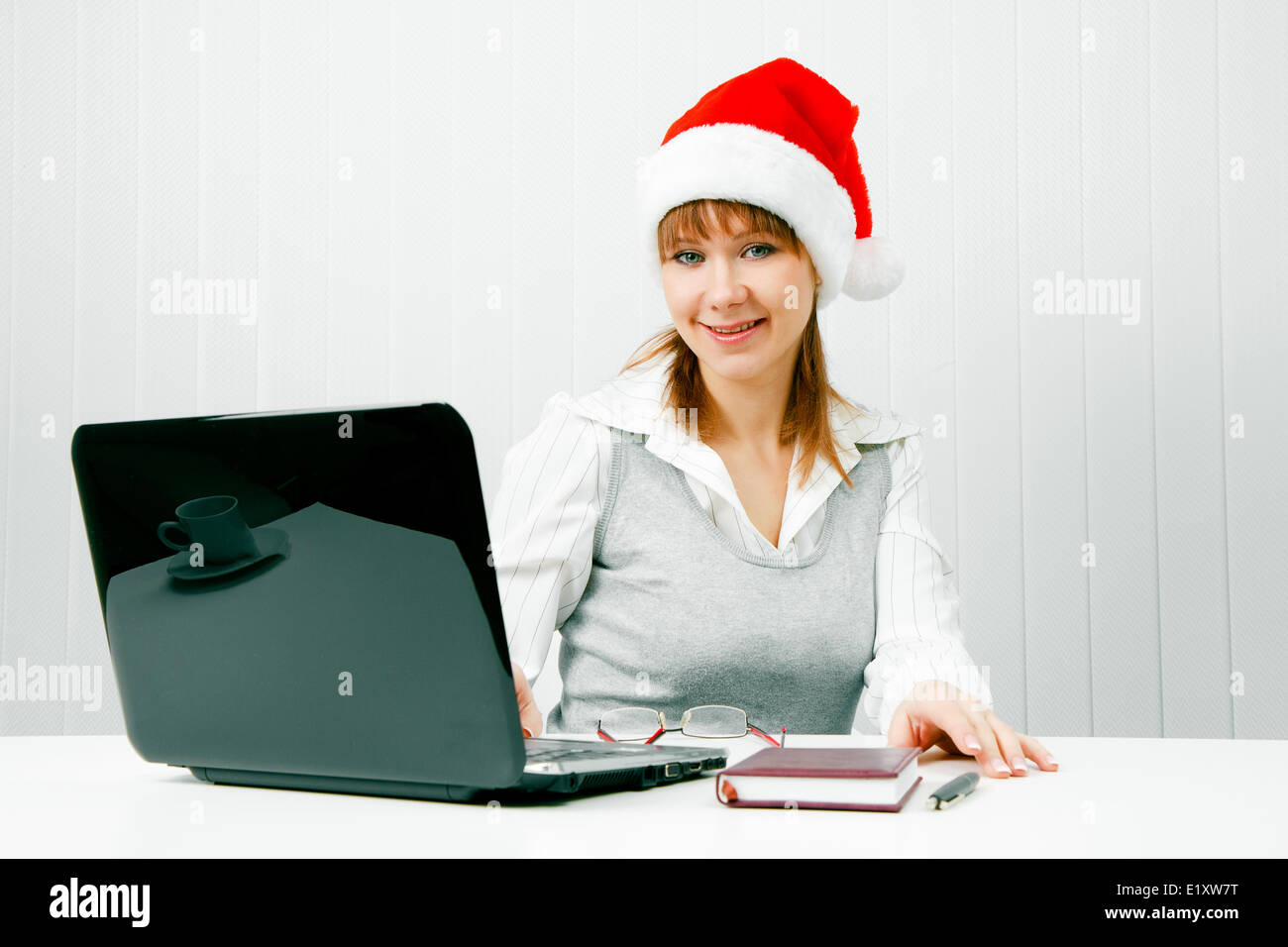 girl in a Christmas hat with a laptop Stock Photo - Alamy