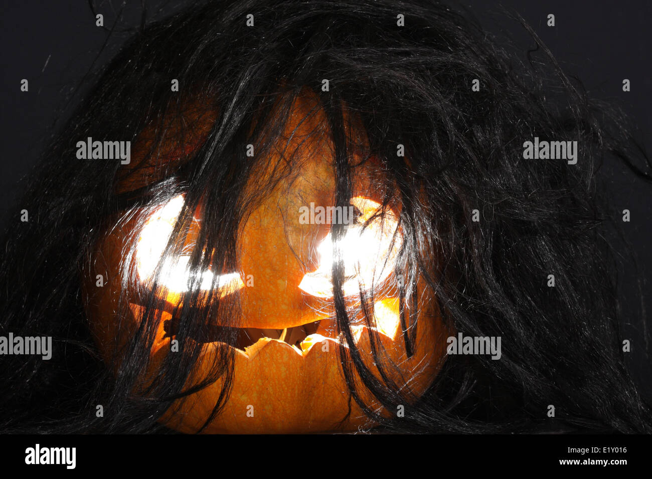 Halloween pumpkin with black hairs Stock Photo