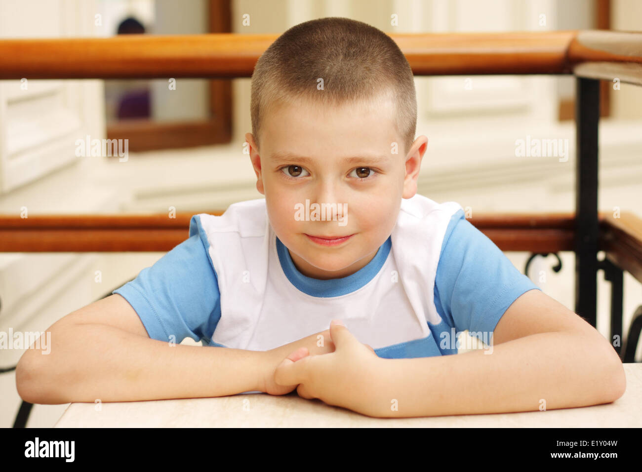 Boy sitting at table Stock Photo Alamy