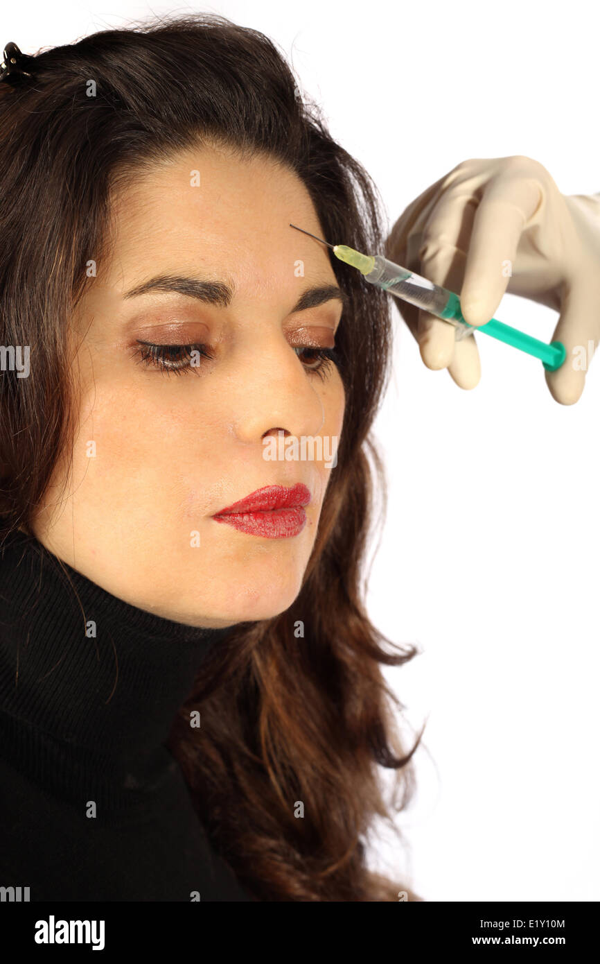 Young woman receives botox injection Stock Photo