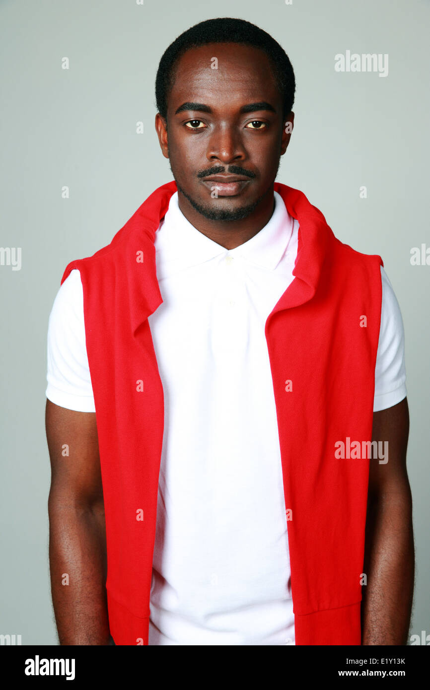 Portrait of a serious african man on gray background Stock Photo - Alamy