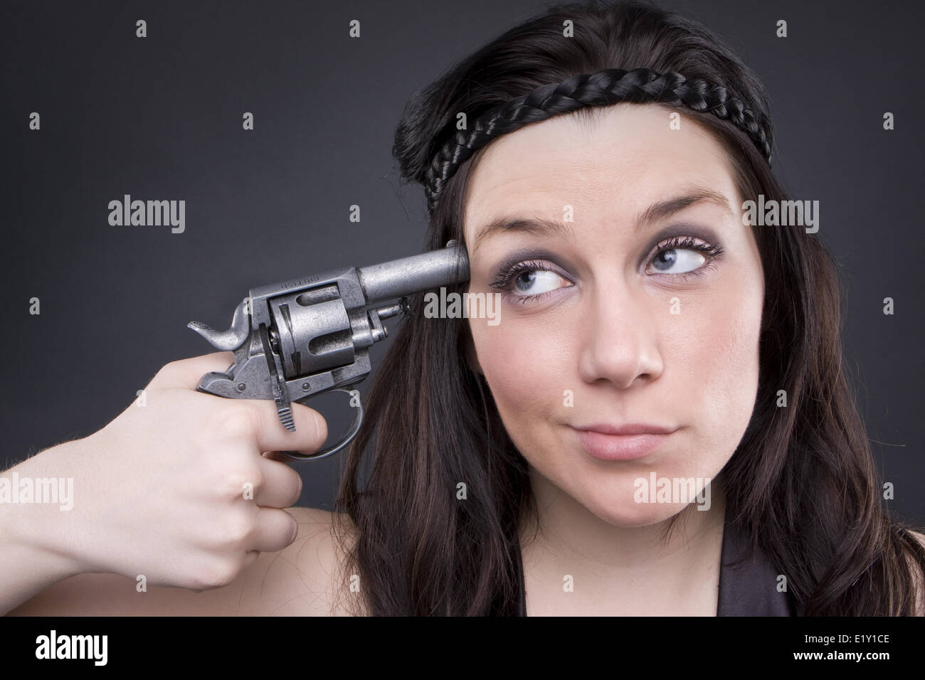 Gun At Womans Head Stock Photo