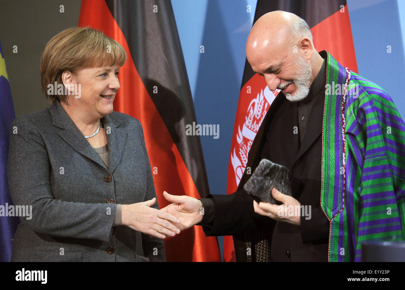 German chancellor Angela Merkel and Afghan president Hamid Karsai shake hands after a press conference in Berlin on the 6th of December in 2011. Stock Photo