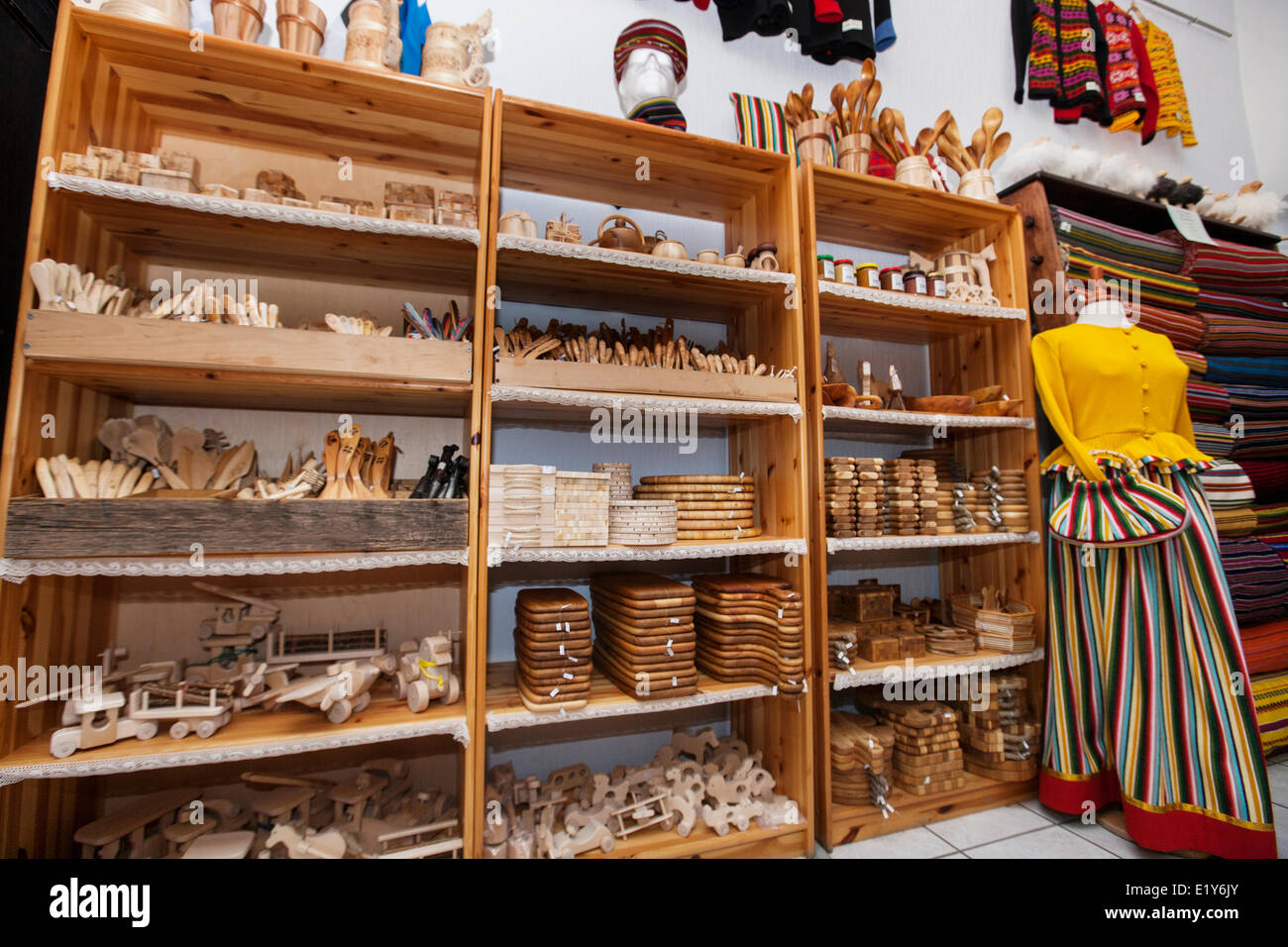 Wooden handicrafts displayed on shelves in gift store Stock Photo