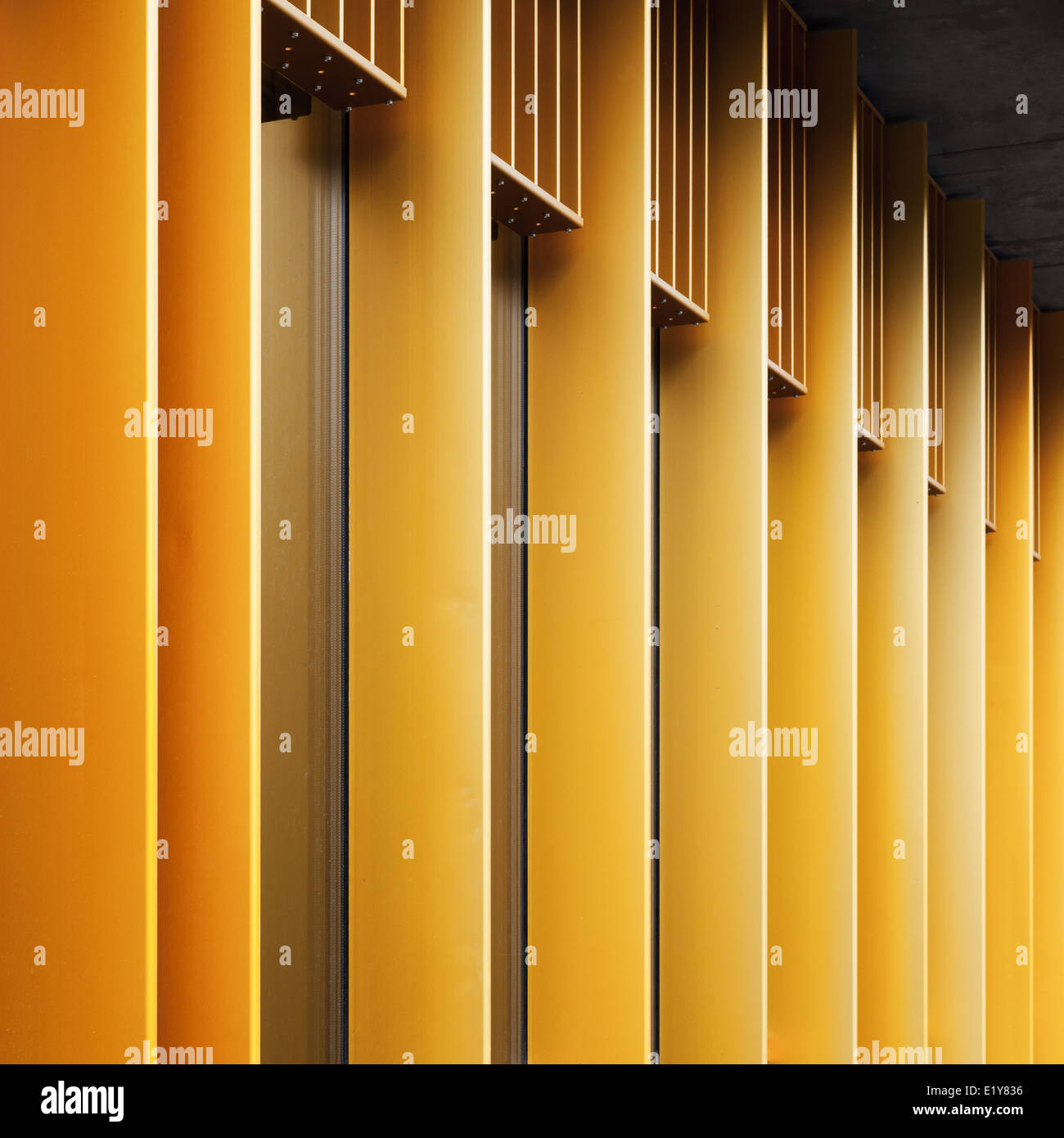 Abstract architecture fragment with yellow metal facade and windows Stock Photo