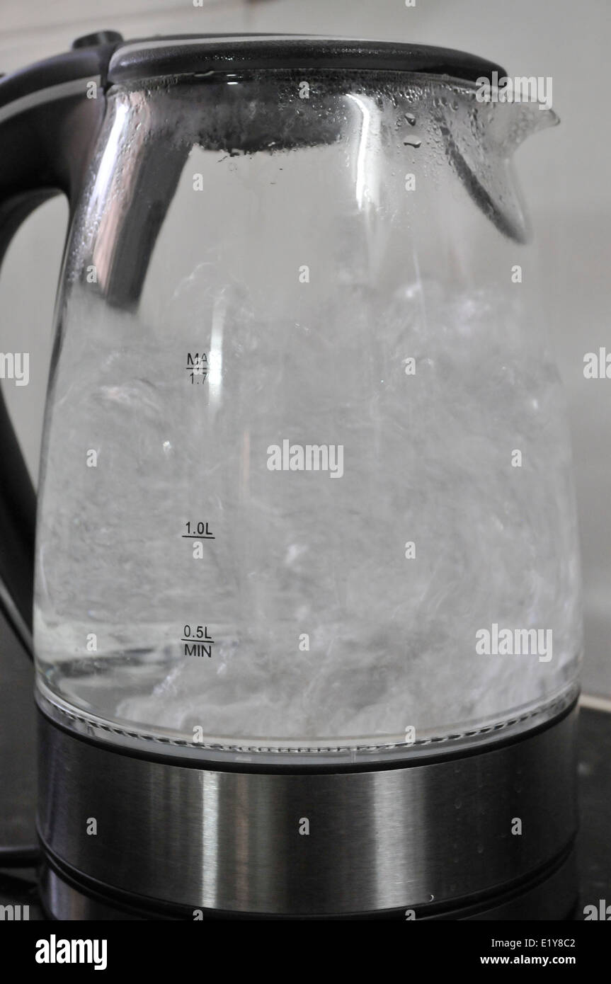 water boiling in a transparent kettle Stock Photo