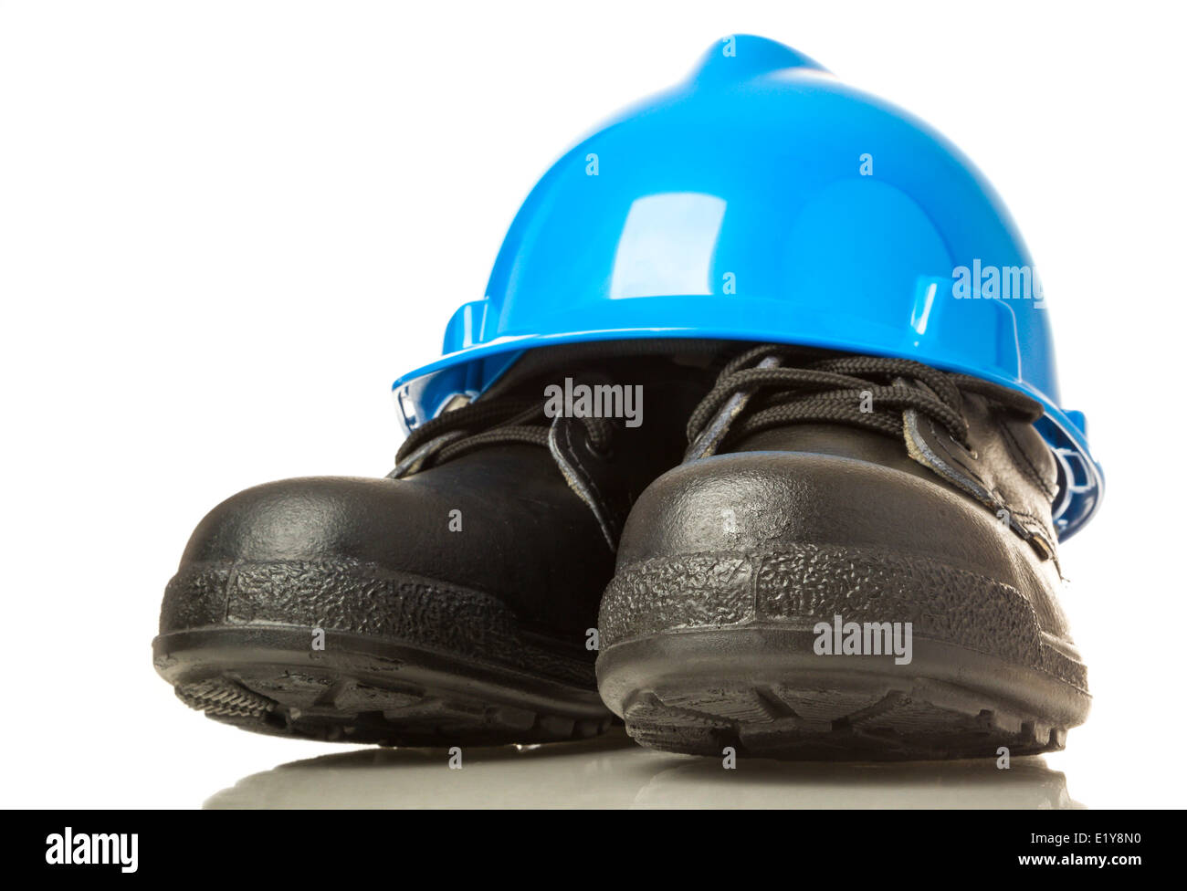 Construction hardhat and work boots on white background Stock Photo