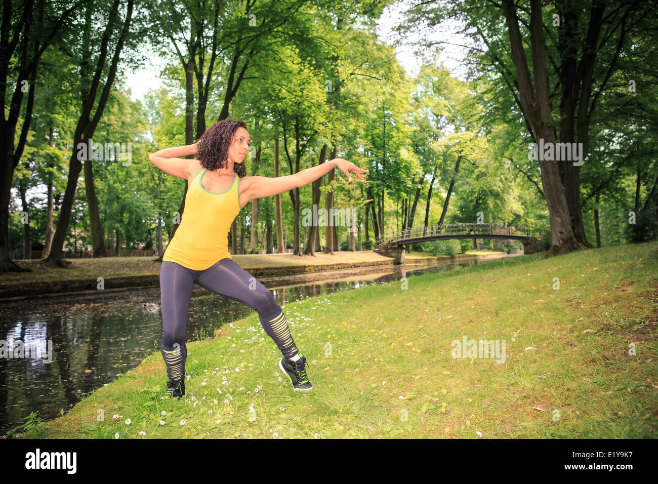 woman dancing the new fitness dance called zumba or aerobics in an old park Stock Photo