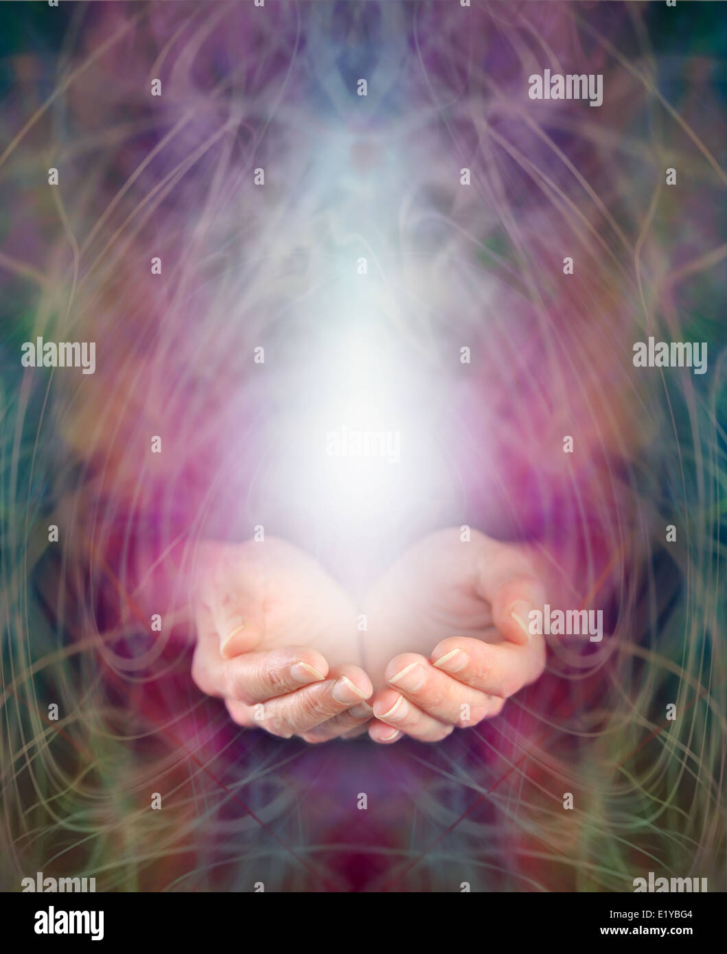 Healer's cupped hands and energy manifestation Stock Photo