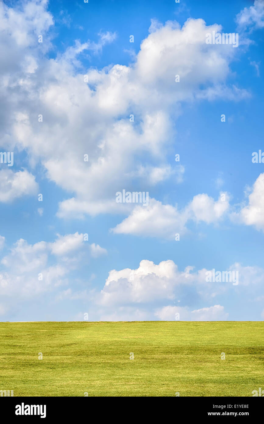 green hill with blue cloudy sky in sunny day Stock Photo