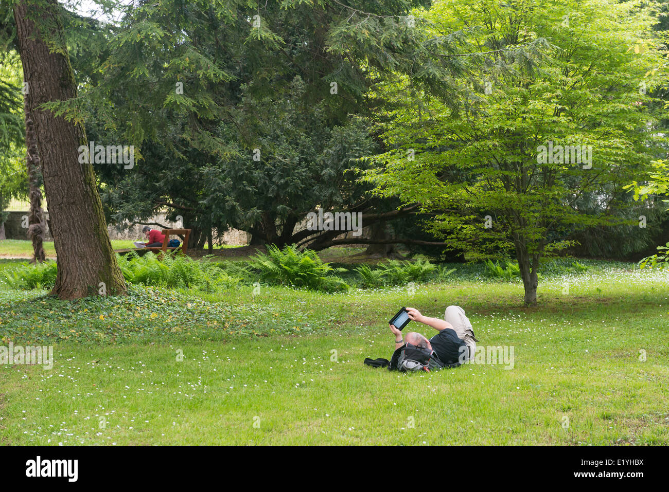 relax in the park with tablet Stock Photo