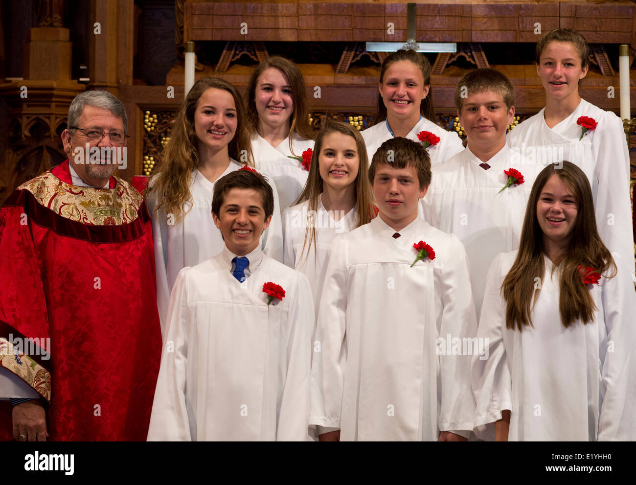 Lutheran teenagers participating in the Rite of Confirmation pose with their pastor at the completion of the service. Stock Photo