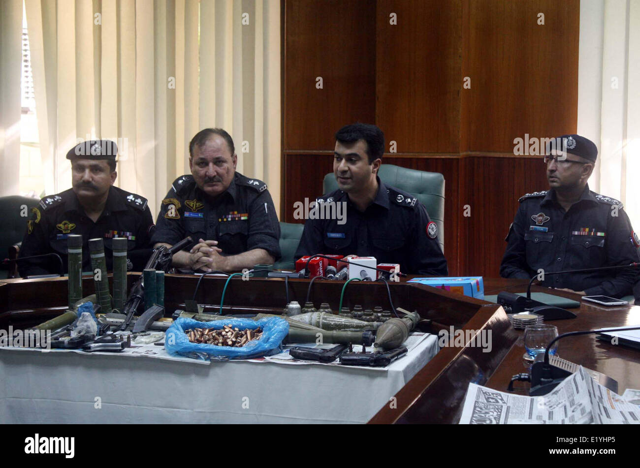 Police officials exposing seized weapons to media persons during a