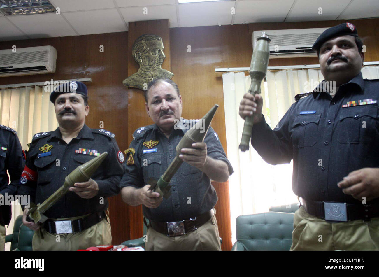 Police officials exposing seized weapons to media persons during a