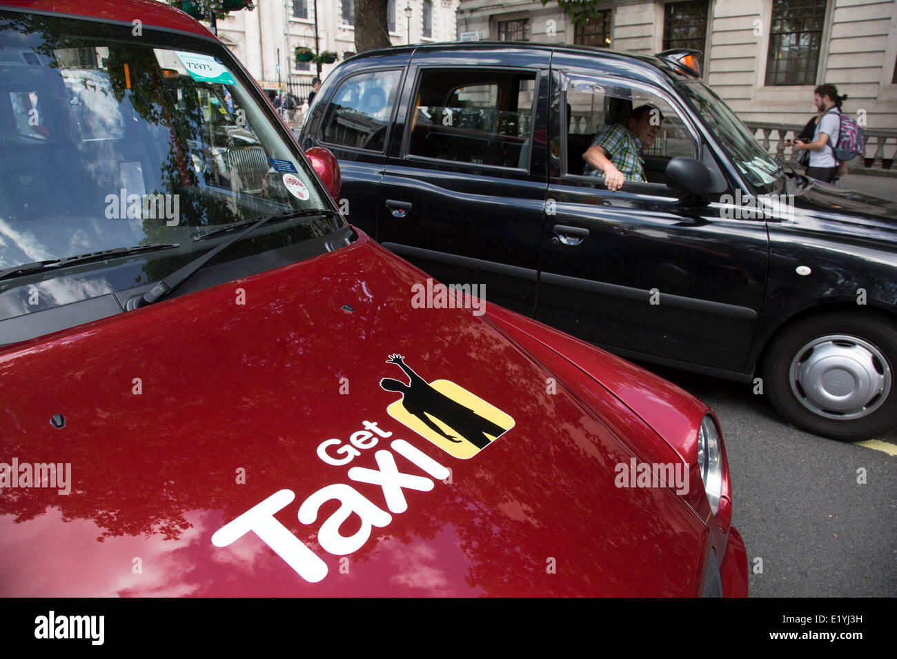 London, UK..11th June 2014. Black taxi drivers protest against taxi service app Uber, brings central London to a standstill. Joined in many numbers by future black cab drivers on mopeds currently doing 'The Knowledge'. London cabbies emphasised that they had no problem with Uber, only with Transport for London for not enforcing current legislation. Credit:  Michael Kemp/Alamy Live News Stock Photo