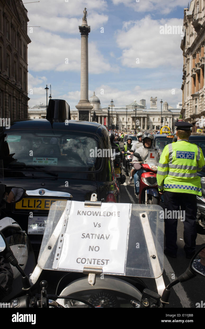 Black taxi cab drivers protest in Whitehall, central London, objecting to a new online booking and journey fare app called Uber. The app works out the cost of journeys and cab drivers say it is the same as using a taxi meter, which only black cabs are legally entitled to use. The London Taxi Driver Association (LTDA) also said part of the demonstration was about highlighting the length of training - between four and seven years - taxi drivers undergo before being licensed. During the protest roads were gridlocked around Parliament Square, Whitehall and Trafalgar Square in capital's West End. Stock Photo