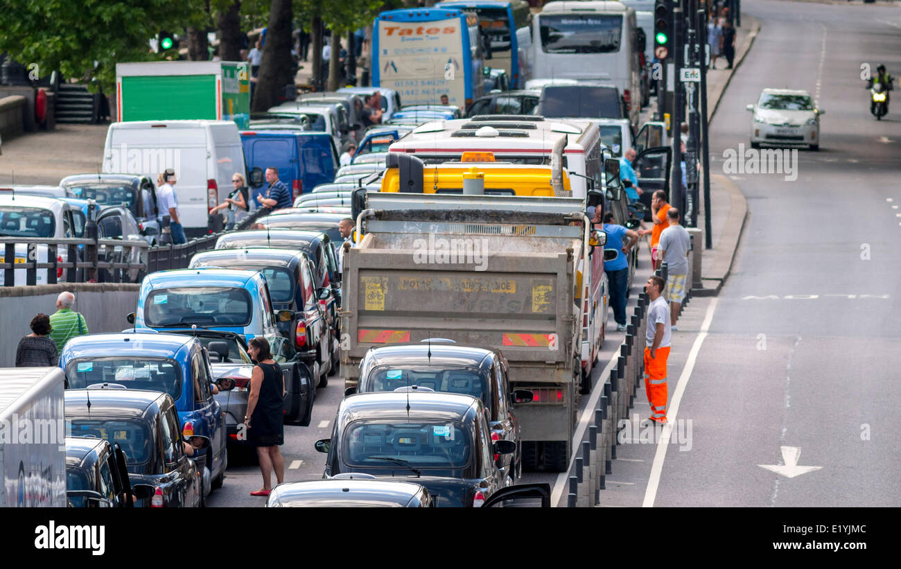 Blackfriars, London, UK. 11th June 2014. London Traffic grinds to a halt as London Black Cabs stage a protest over the launch of a smartphone app called Uber which allows customers to book a taxi from their location using a smartphone. Black Cab Drivers claim the Uber is not regulated enough, The protest was supposed to be over by 3pm but looks set to cause traffic problems for the rest of the day. Credit:  Lenscap/Alamy Live News Stock Photo