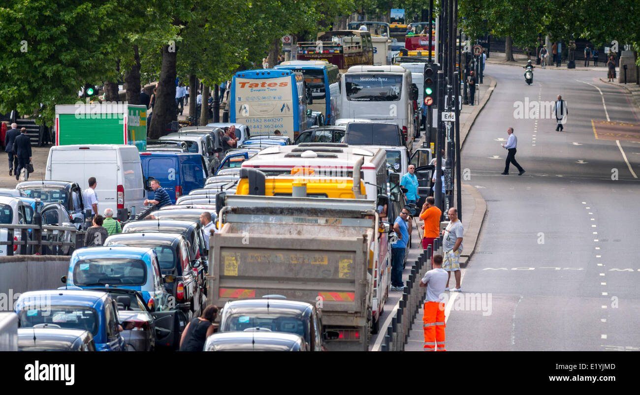 Blackfriars, London, UK. 11th June 2014. London Traffic grinds to a halt as London Black Cabs stage a protest over the launch of a smart phone app called Uber which allows customers to book a taxi from their location using a smartphone. Black Cab Drivers claim the Uber is not regulated enough, The protest was supposed to be over by 3pm but looks set to cause traffic problems for the rest of the day. Credit:  Lenscap/Alamy Live News Stock Photo