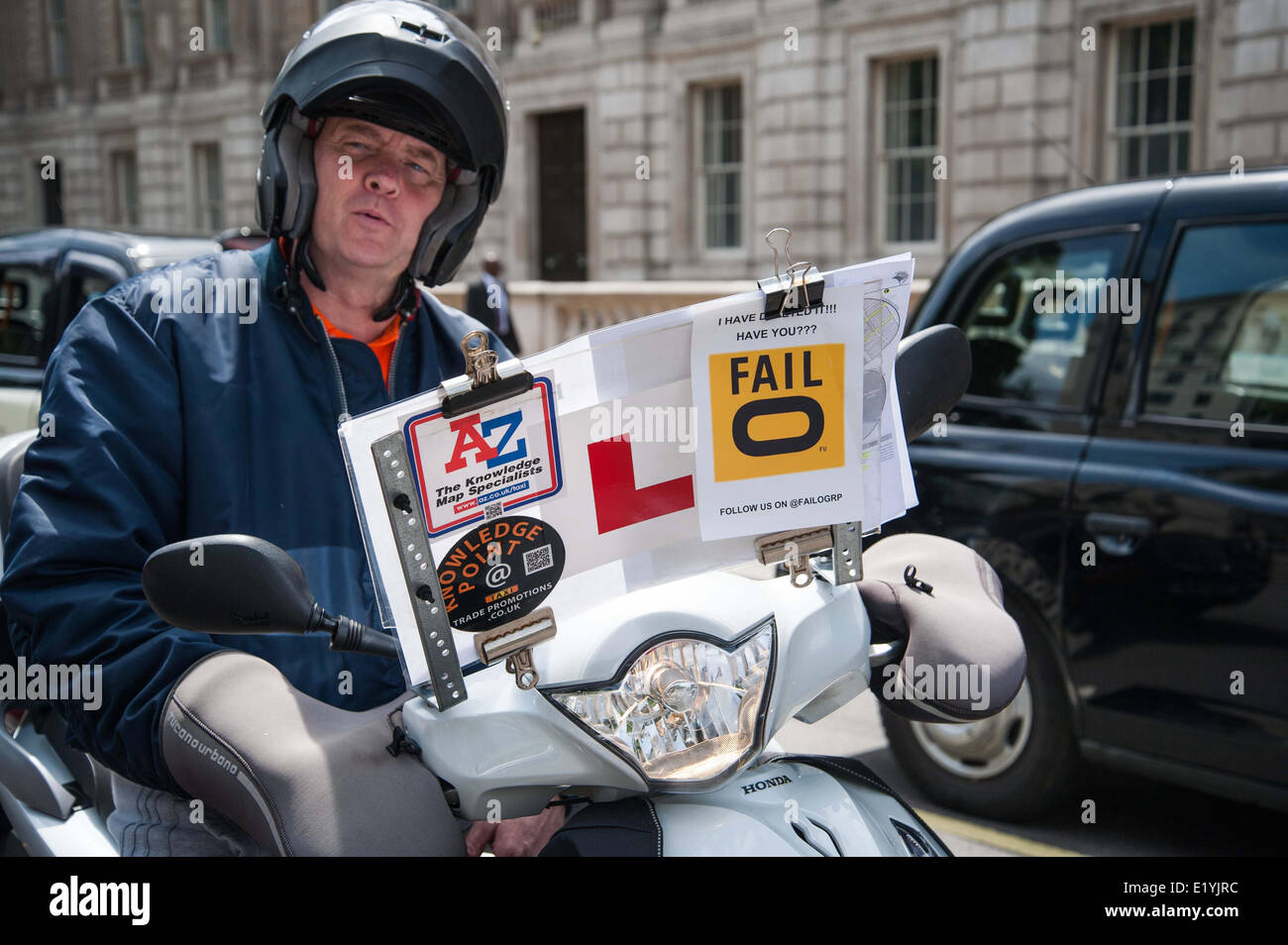London, UK. 11th June 2014.  A driver taking the knowledge has anti-TfL and ant-Uber flyers on his screen as Taxi drivers hold an anti-Uber protest in Central London. A series of protest have been held across Europe by traditional taxi services who are angry about the lack of regulation of the cab firm Uber. Credit:  Pete Maclaine/Alamy Live News Stock Photo
