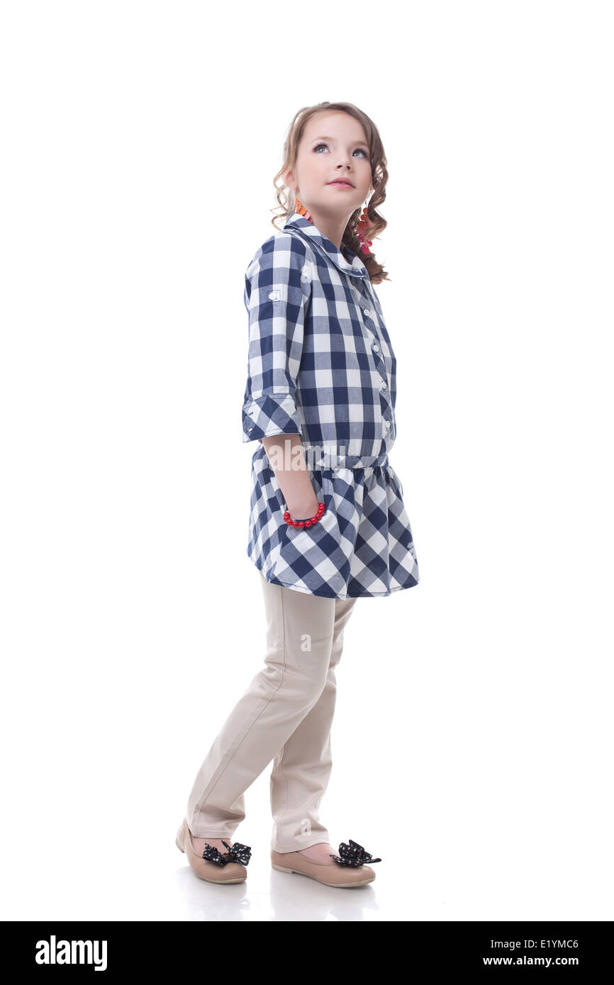 Adorable stylish little girl posing looking up Stock Photo - Alamy