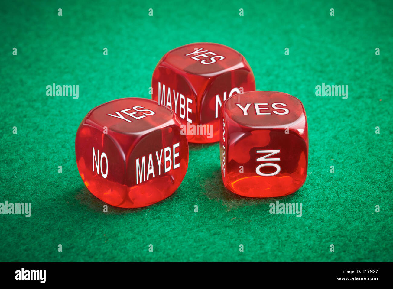 Chance concept, three red dice on a green felt background. Stock Photo