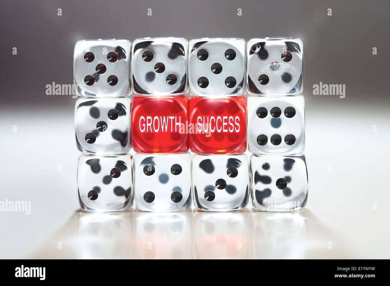 The words, Growth and Success on two red dice Supported by clear dice. Strength, unity And Clarity concept. Stock Photo