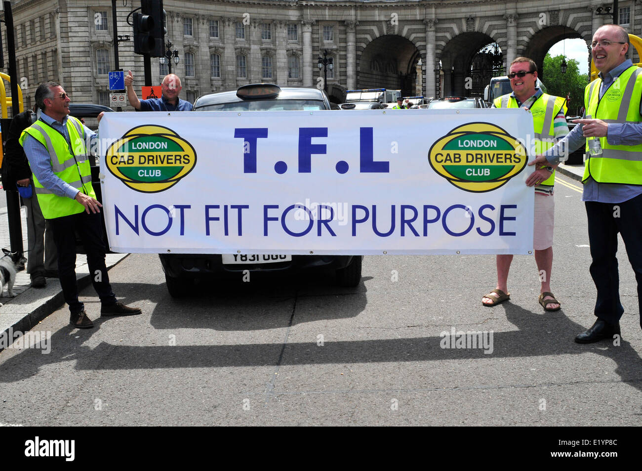 Black cab drivers hold a banner reading ' TFL not fit for purpose' Stock Photo