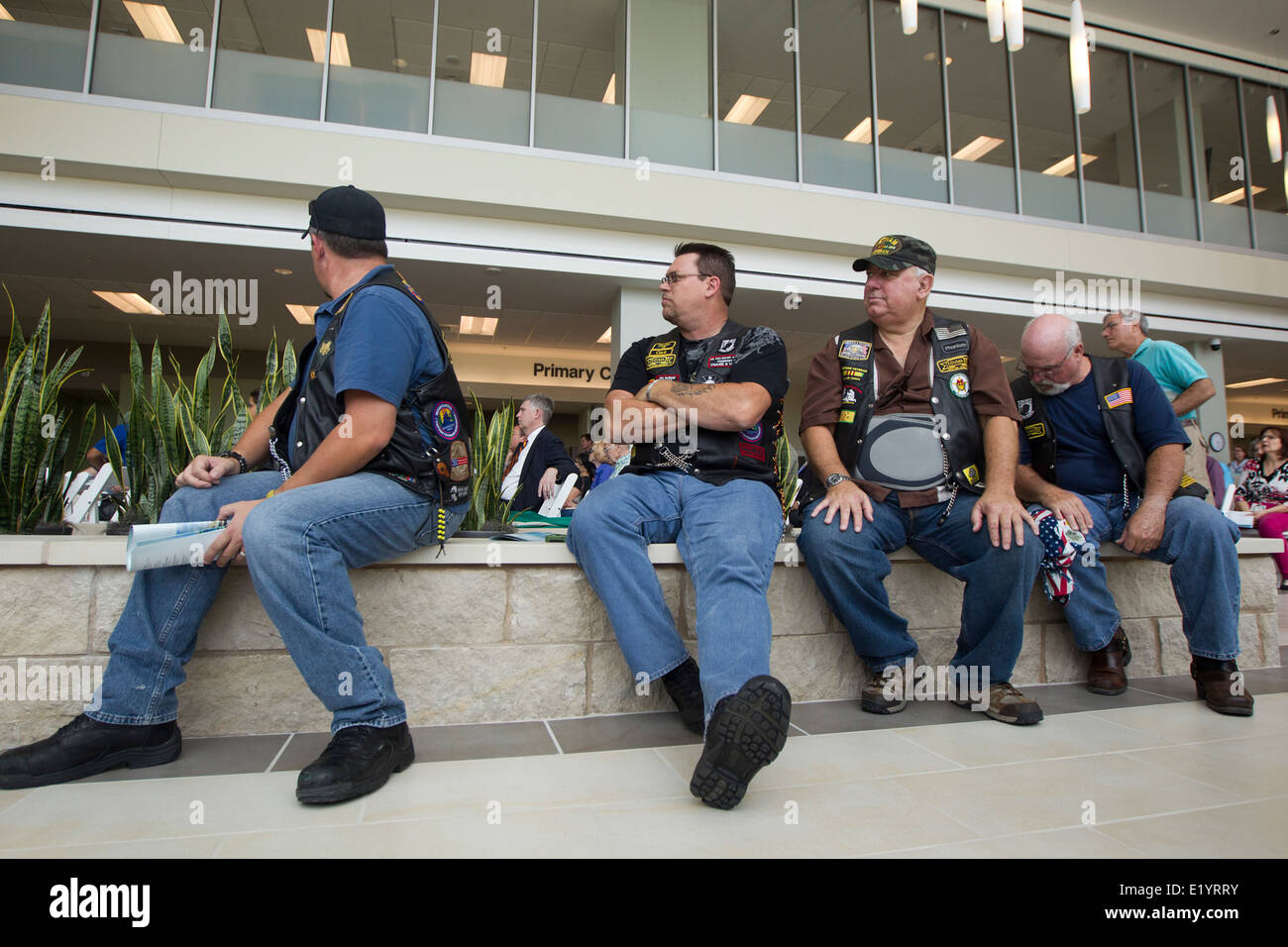 U.S. military veterans wait in the lobby area during grand opening of Veterans Administration outpatient clinic in Austin TX. Stock Photo