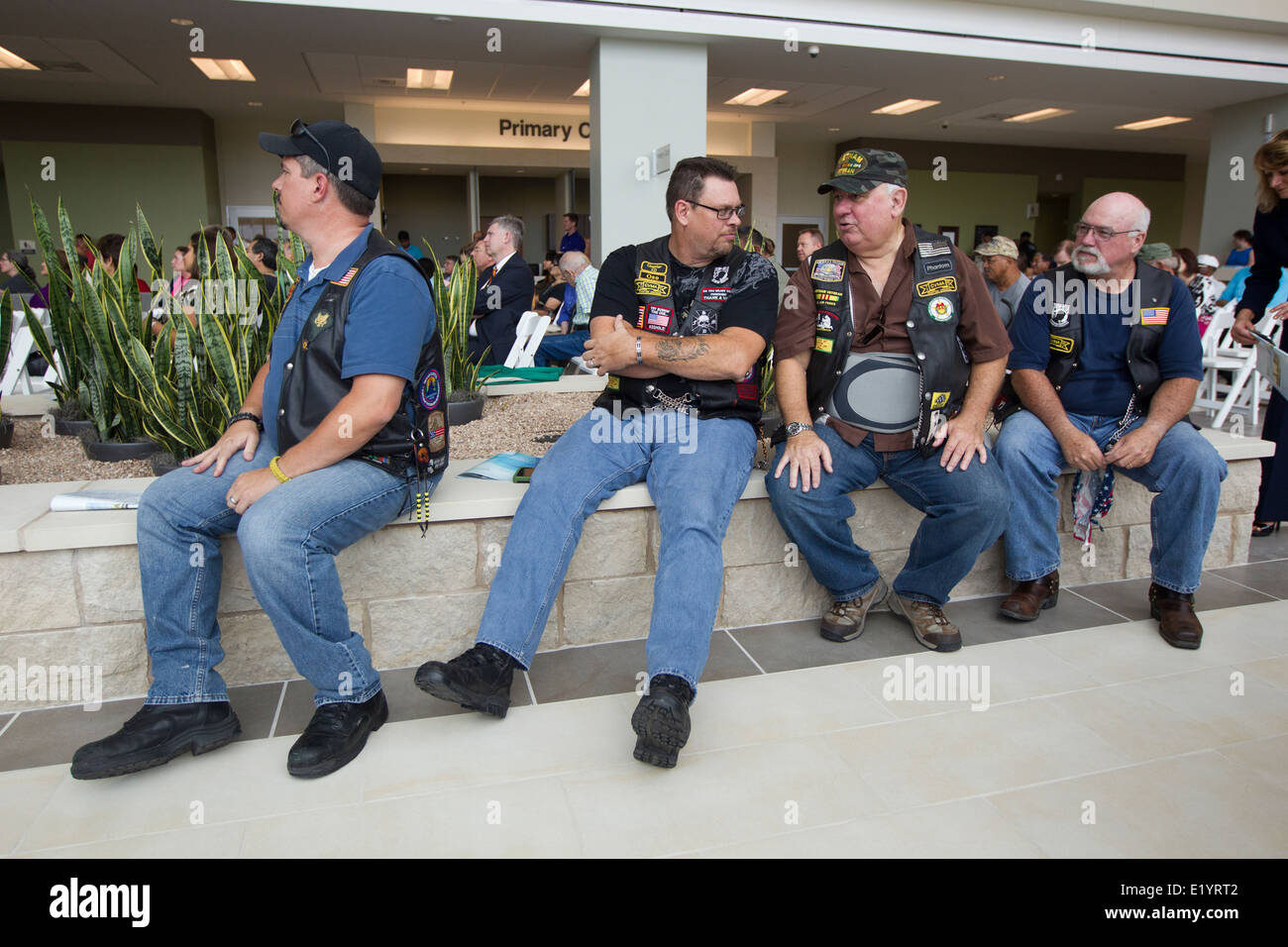 U.S. military veterans wait in the lobby area during grand opening of Veterans Administration outpatient clinic in Austin TX. Stock Photo