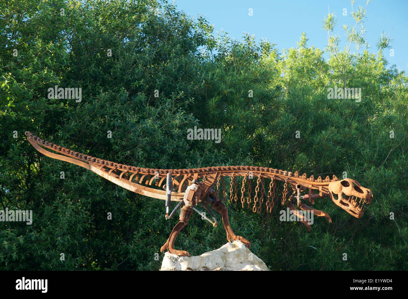 Large Sculpture of a running bipedal dinosaur created out of recycled scrap metal by Mowlam Metalcraft of Dorchester. Dorset, England, United Kingdom. Stock Photo