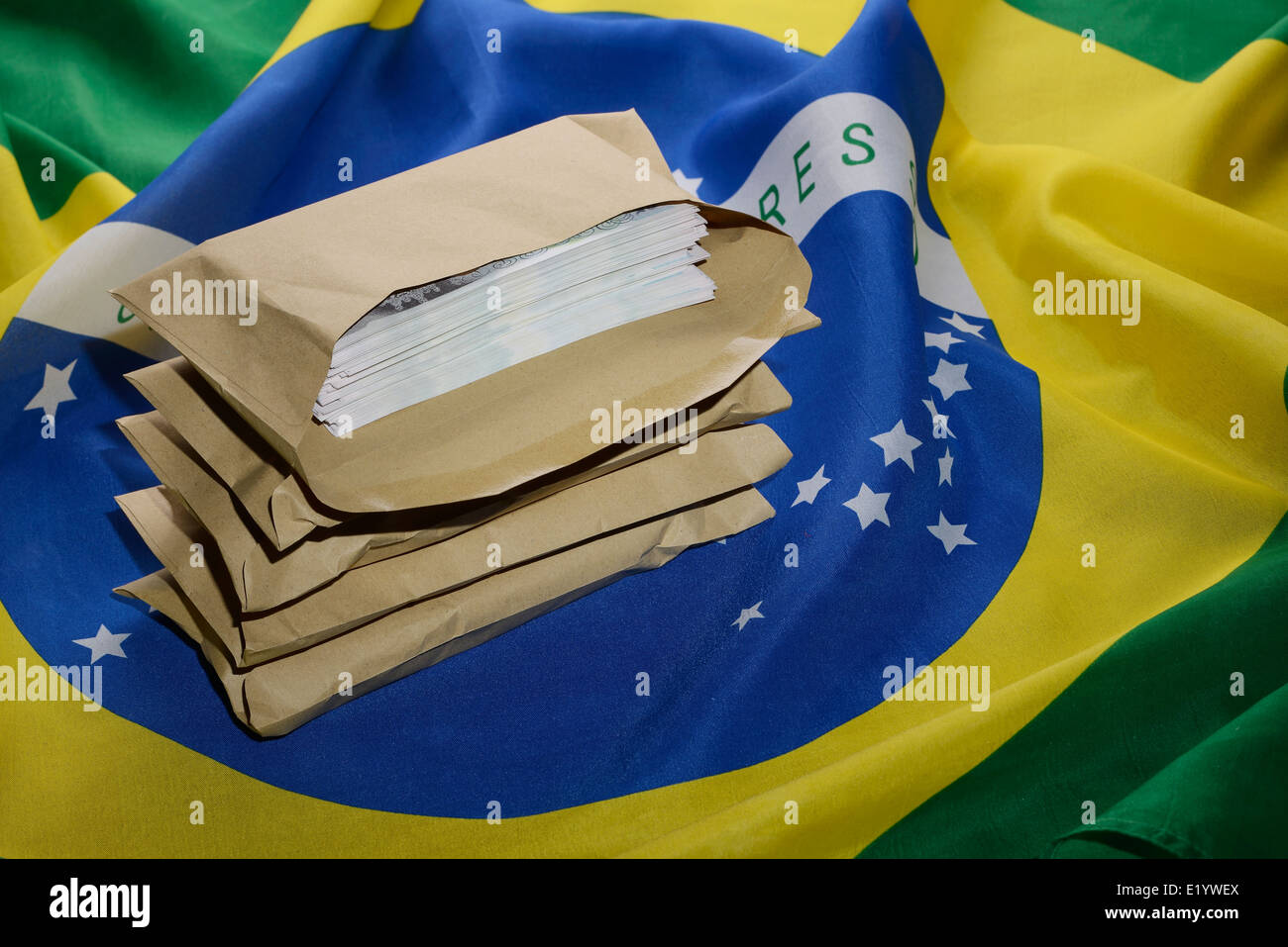 Brazil flag with brown envelopes full of money Stock Photo
