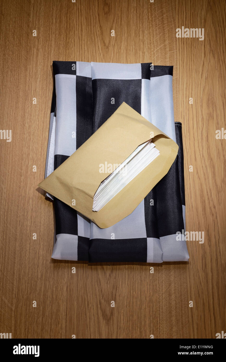 Chequered flag with a brown envelope full of money Stock Photo