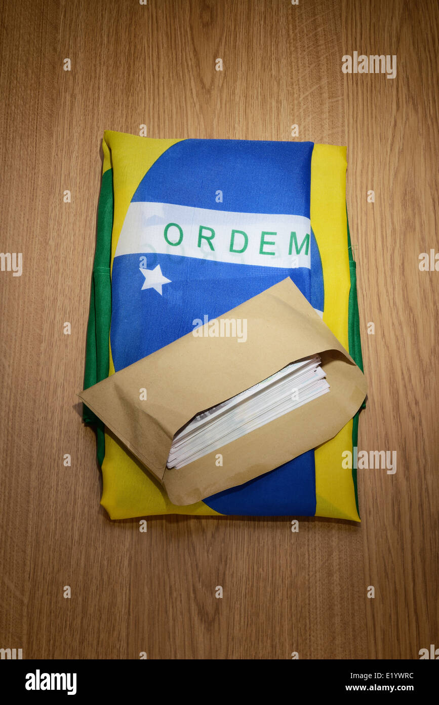 Brazil flag with a brown envelope full of money Stock Photo