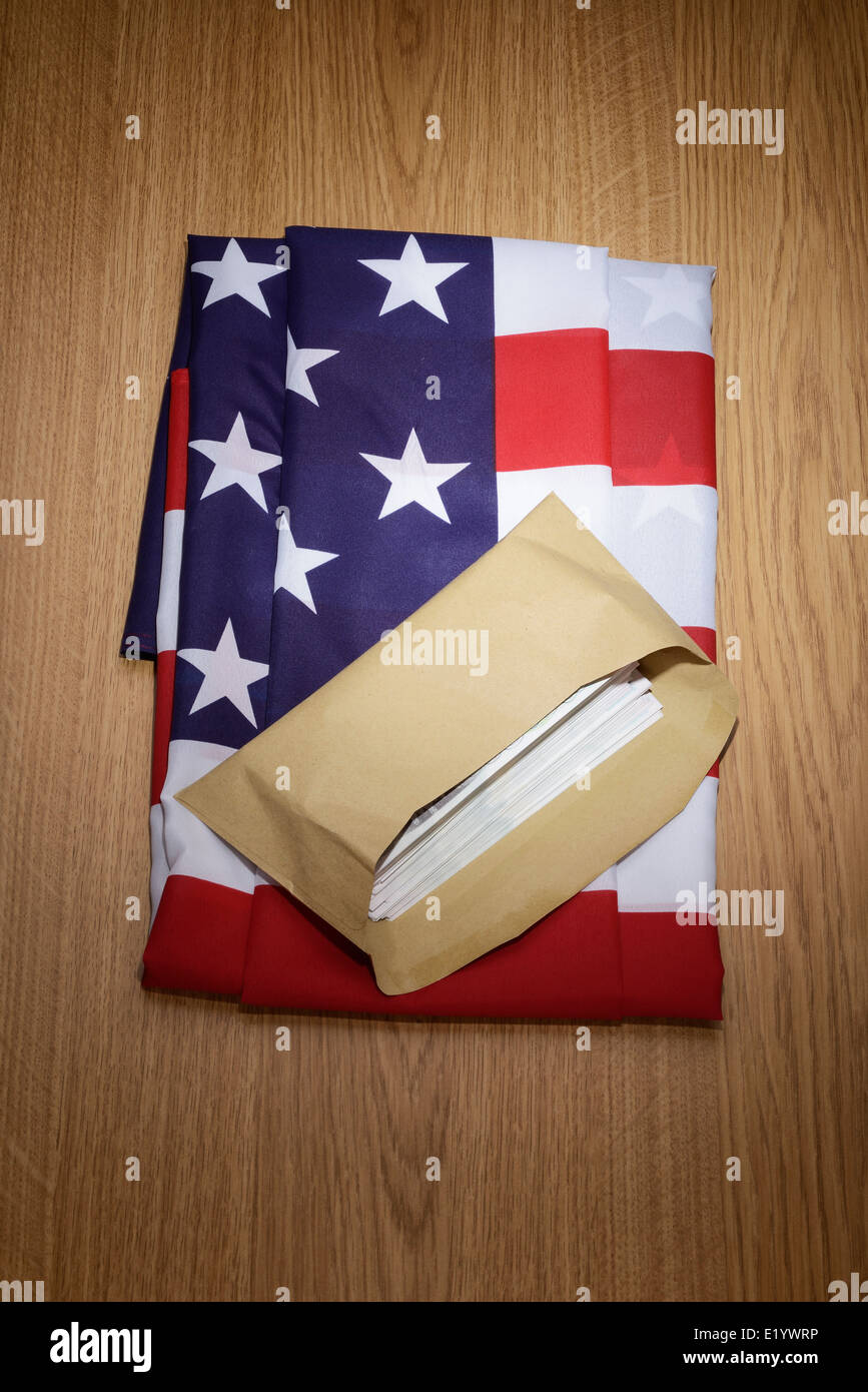 USA flag with a brown envelope full of money Stock Photo
