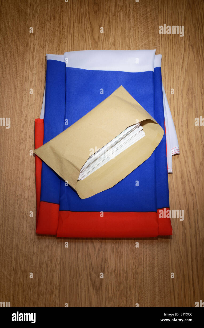 Russia flag with a brown envelope full of money Stock Photo