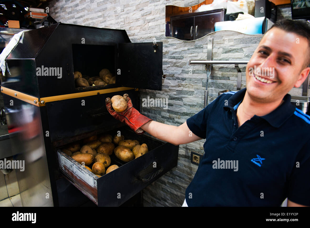 Kumpir  (A mega big baked potato stuffed with many tasty fillings) Potato is a very popular street food in the Ortakoy ,Istanbul Stock Photo