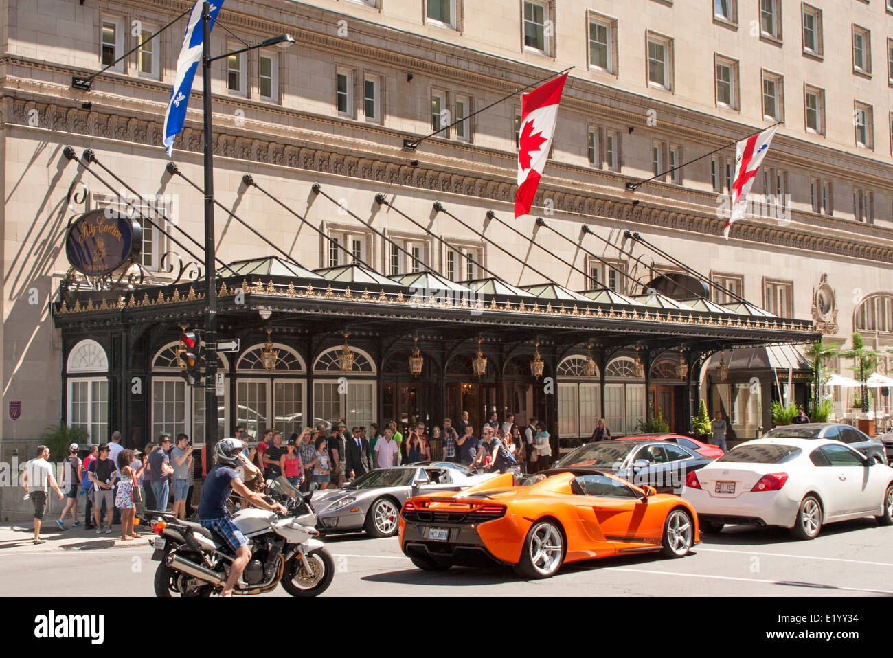 Expensive sports cars pass the Ritz Carlton Montreal Hotel on Formula 1 Grand Prix weekend Stock Photo